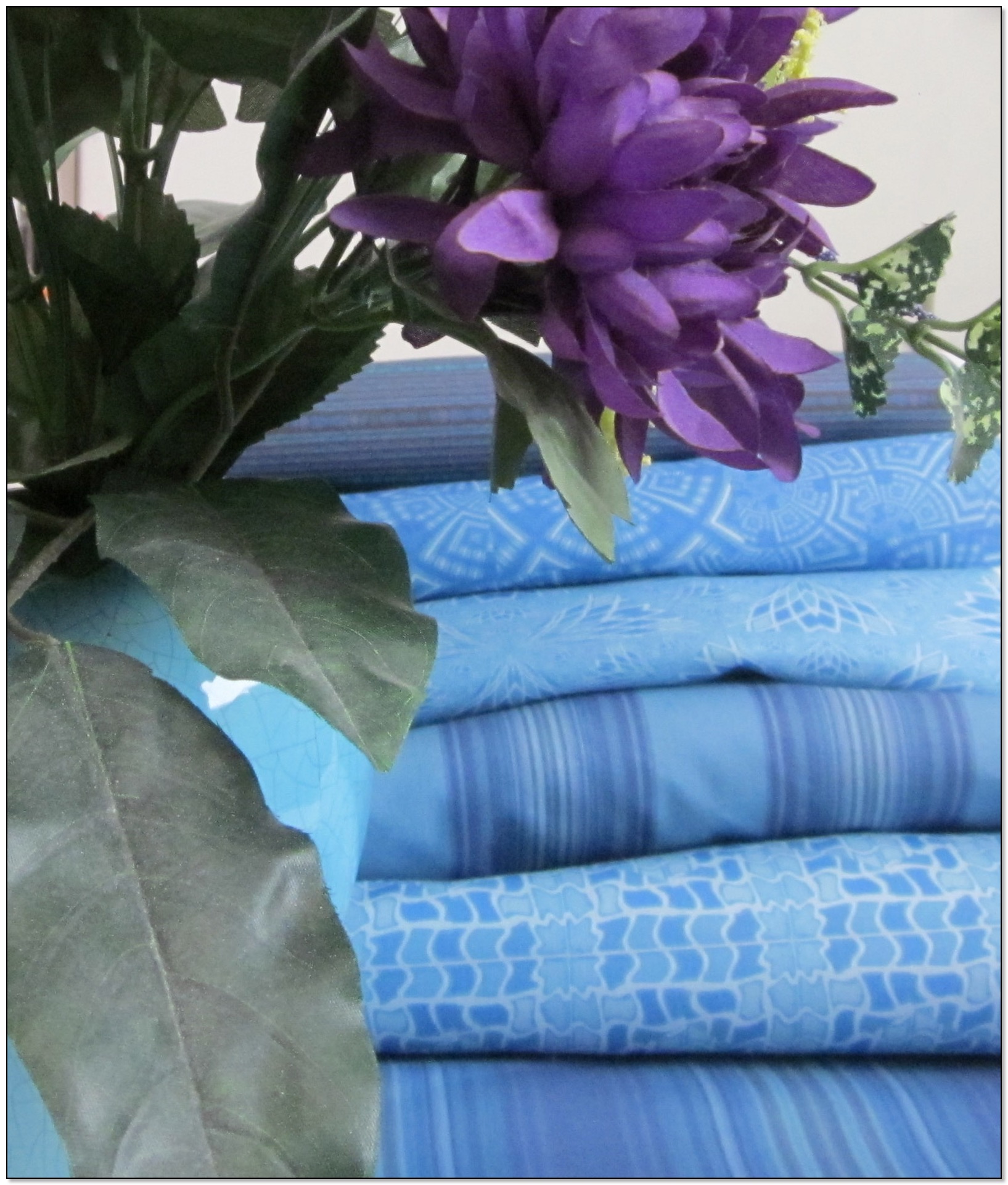 A stack of Gingezel blue fabric.